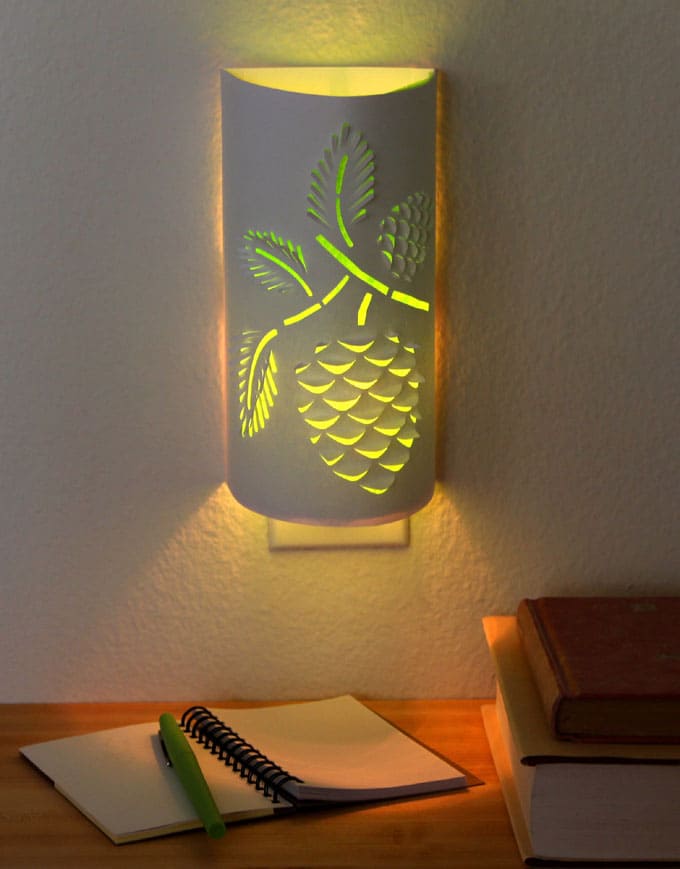 Transform a plain night light into an enchanting paper lantern. Download the flower or pine cone designs to make your own functional art that glows! - A Piece of Rainbow