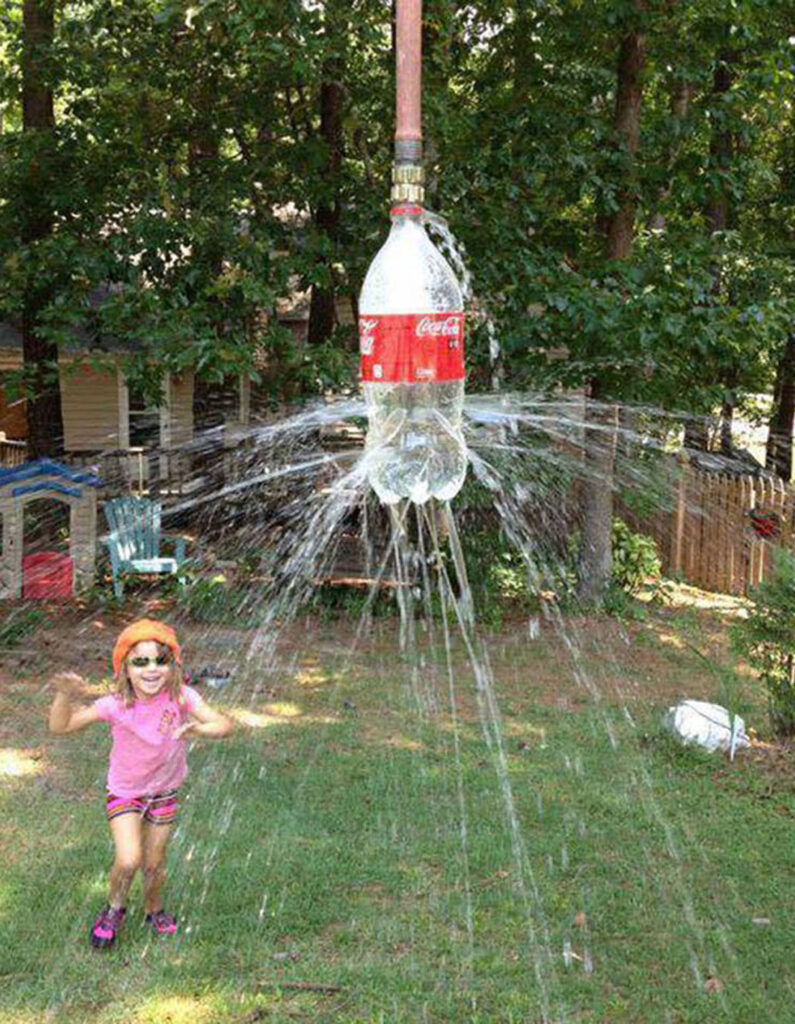 plastic bottle hanging shower sprinkler in backyard