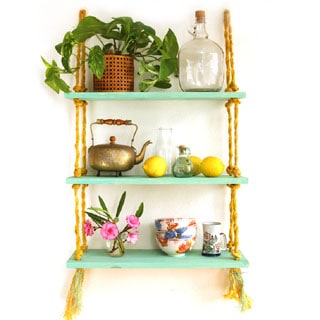 Easy to build and hang, this beautiful gold and turquoise DIY rope shelf is also collapsible. All you need is a drill to build it!