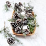 candles and DIY snow covered pine cones & branches in wood tray