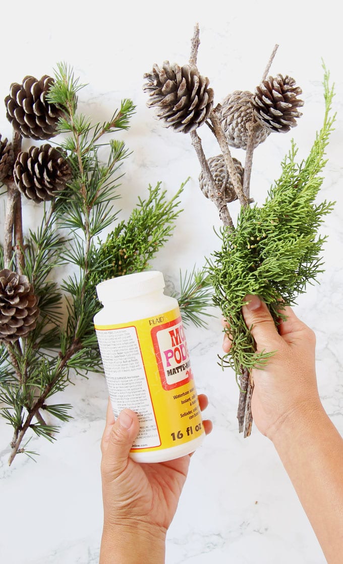 How to make DIY snow covered pine cones & branches with artificial snow or glitter.