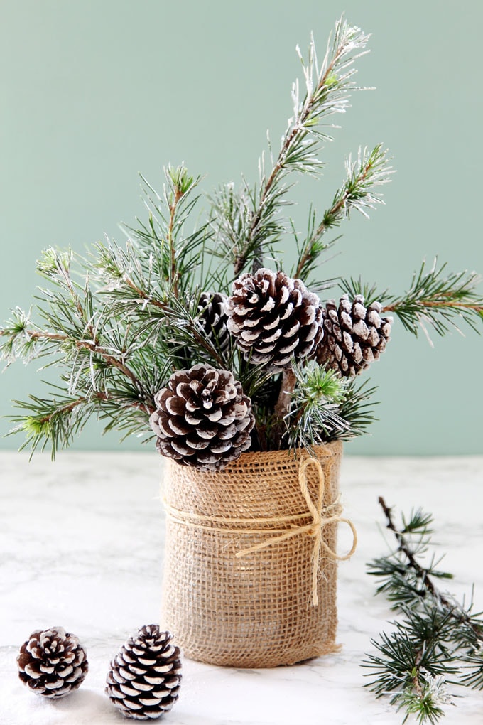 Festive Christmas centerpieces arrangement with candles, ornaments, and greenery