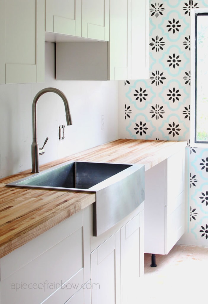  white IKEA kitchen with Sektion IKEA kitchen cabinets, farm sink, butcher block countertop 