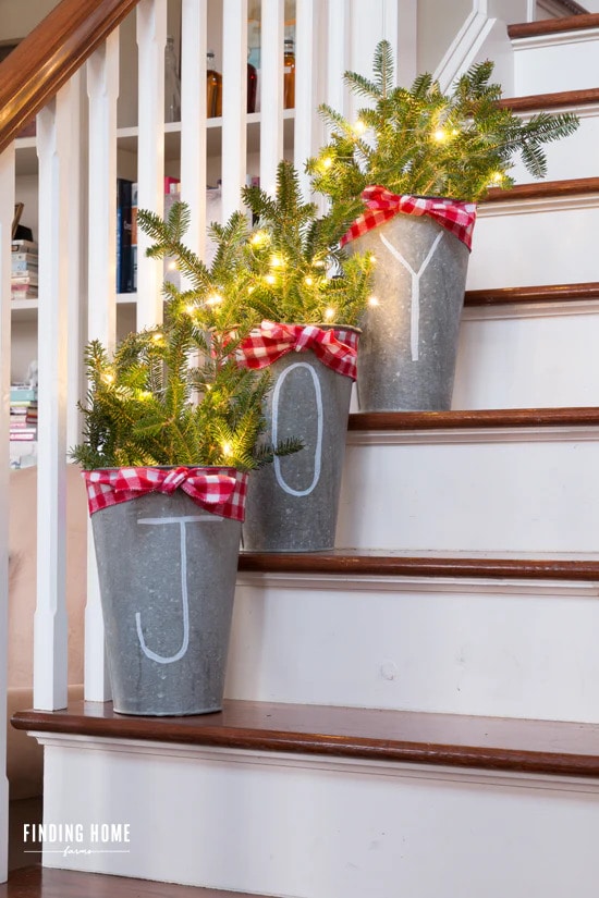 Decorate Christmas stairs with farmhouse tin buckets