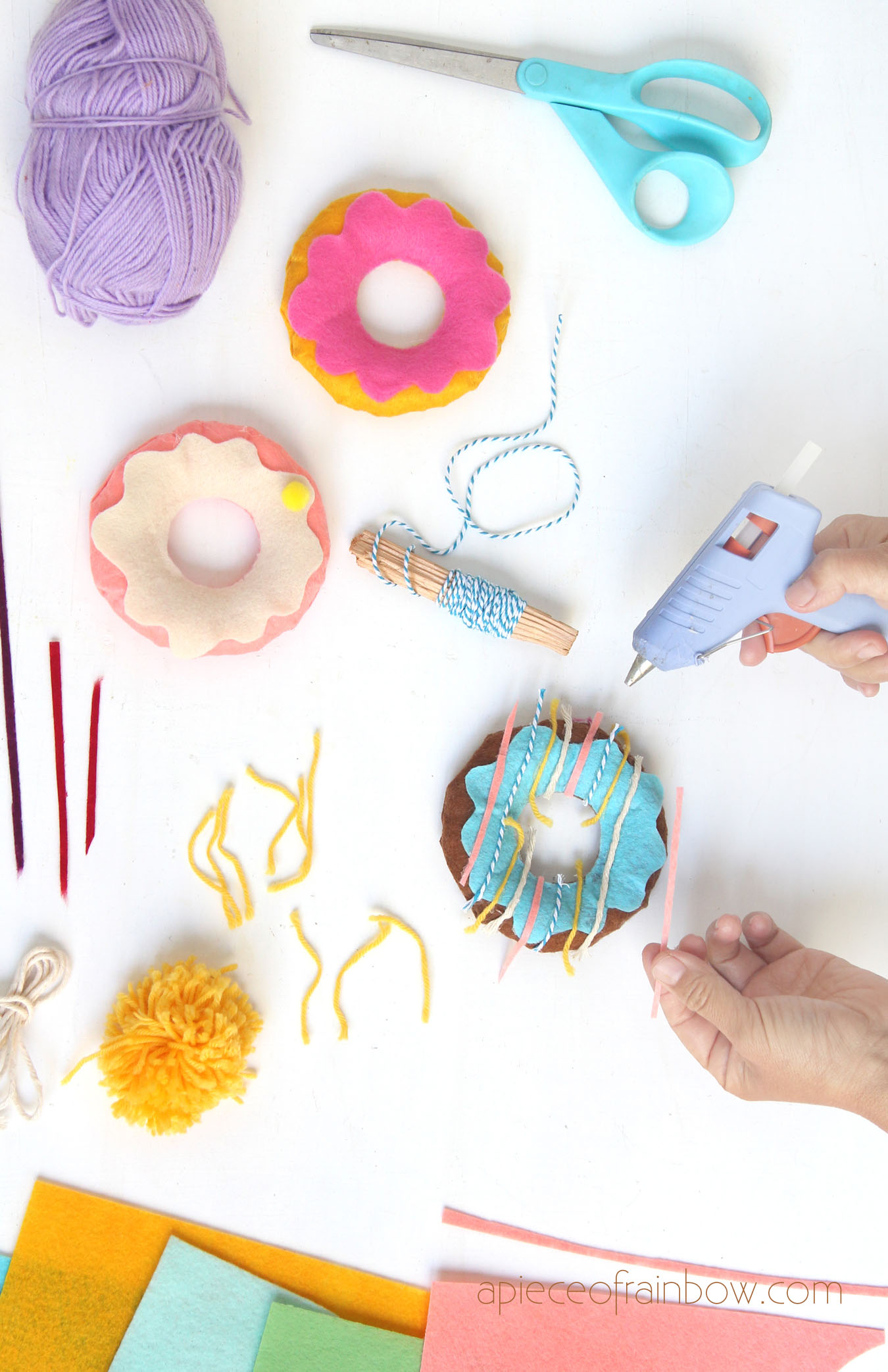 use colorful twine, yarn, pompoms, felt scraps to make sprinkles and toppings on the felt donuts