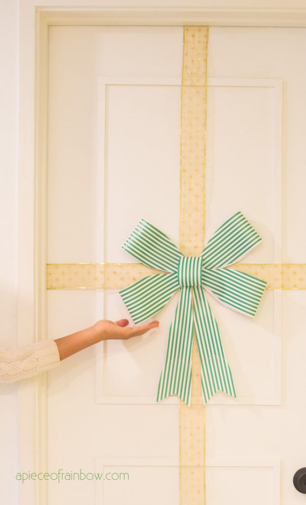Christmas door decorations with gold ribbon and green DIY paper bow