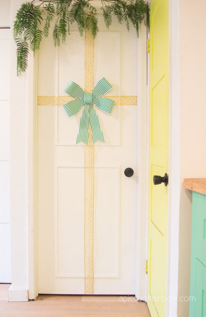DIY Christmas door decorations  with green bow and gold ribbon.