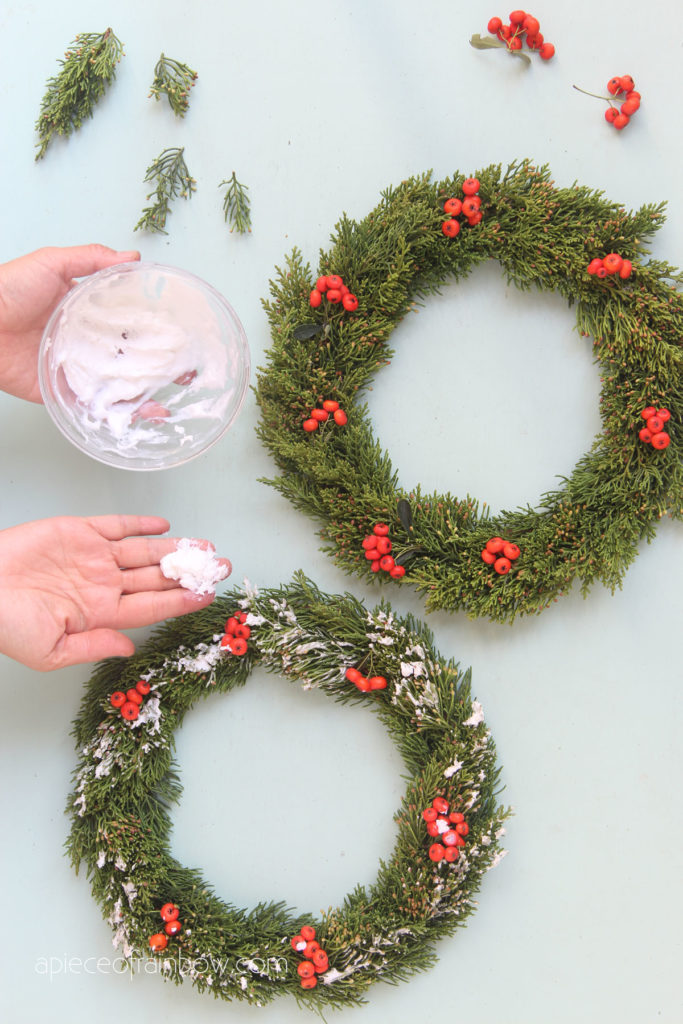  DIY snow flocked Christmas cabinet wreaths made from cardboard and fresh conifer clippings. 