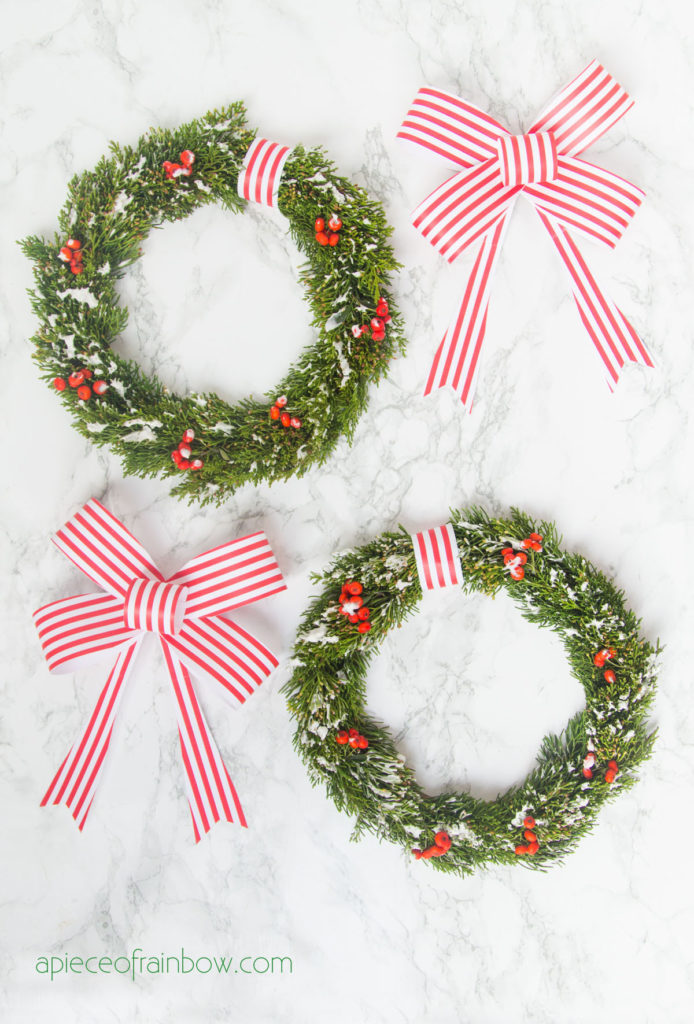 glue the paper Christmas ribbon bow to the cabinet wreaths