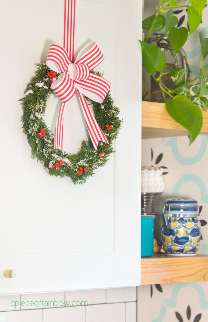  DIY Christmas wreath on white kitchen cabinets