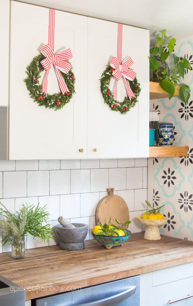 Anthropologie modern farmhouse kitchen with Christmas decorations & cabinet wreaths
