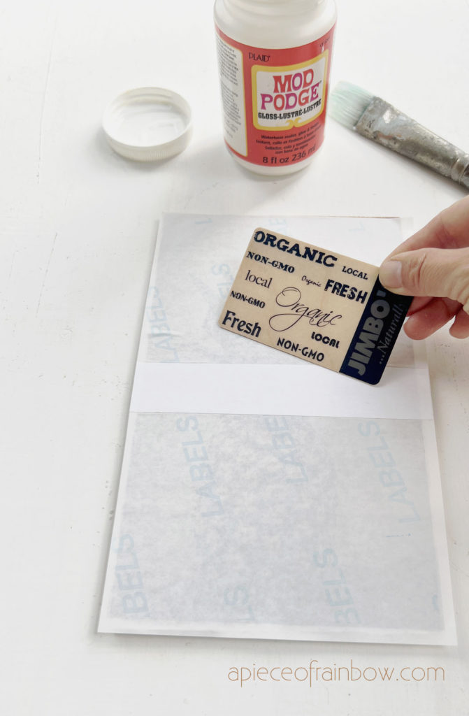 Use  a card to smooth out the paper and press the paper down  on the wood surface