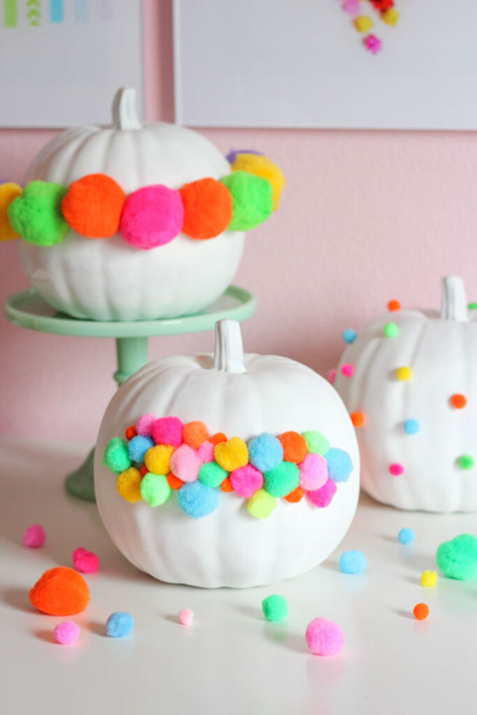 Colorful boho pumpkin decorating ideas with pompoms