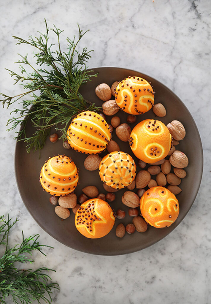 clove studded oranges in a bowl