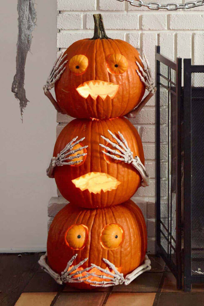 Carved pumpkin faces with skeleton arms