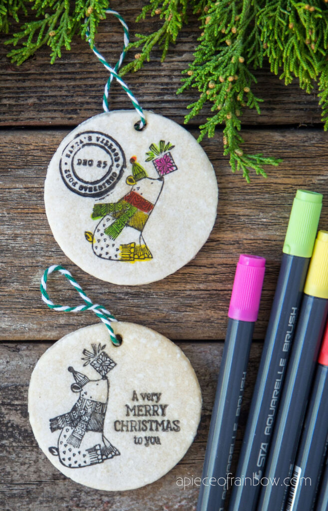  stamping salt dough ornaments with a Santa's village stamp and a Merry Christmas stamp