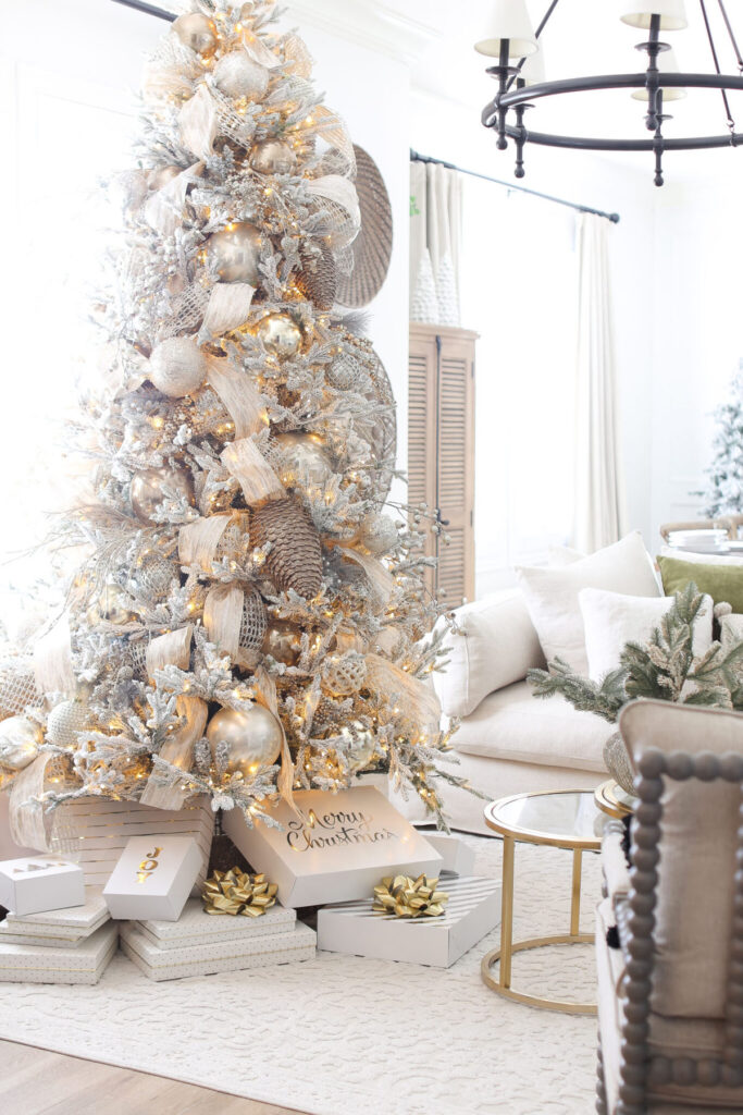 Modern glam Christmas tree decorating with gold ribbons   