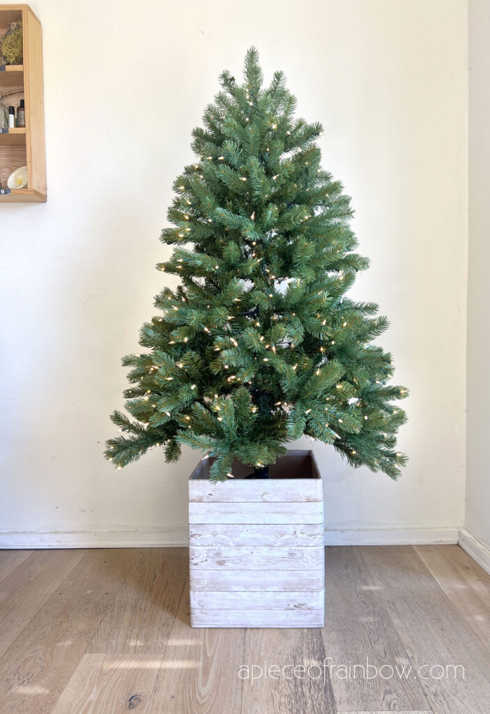 elevated Christmas tree stand that looks like a modern farmhouse wood planter box